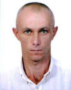 Portrait of a serious bald man in a navy suit, representing a pest control expert in Southern Ukraine.